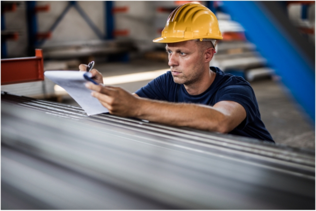 worker inspecting items on product line